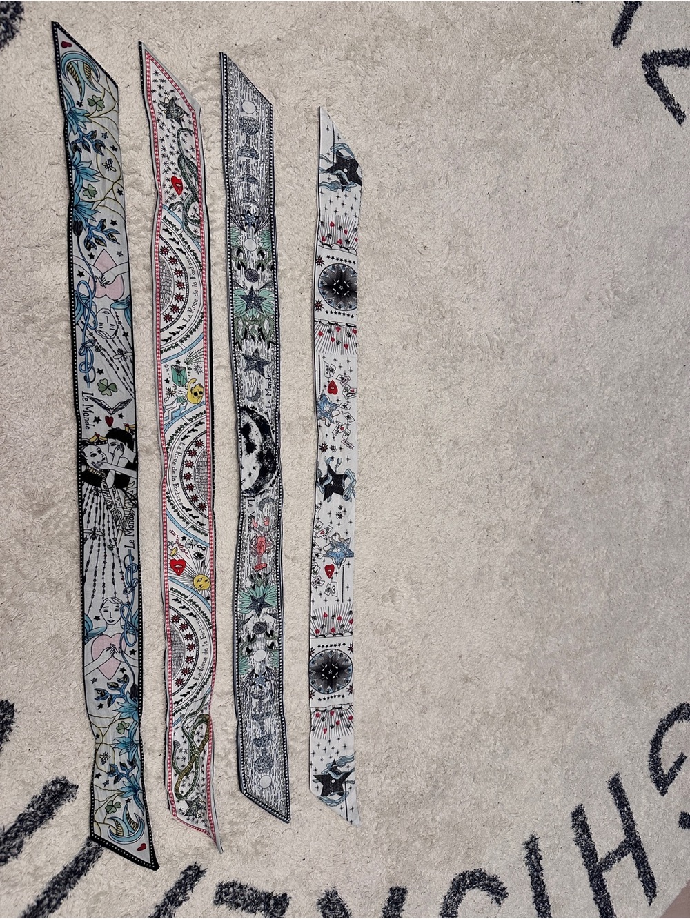 A set of 4 le monde slim scarves